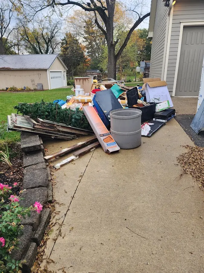 Dumpster being loaded with debris for 3 Yard Dumpster Rental in Fresno